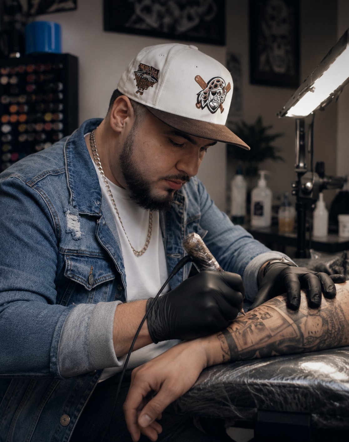 Ismael Miramontes, tattoo artist and owner of Ish Tattoos LLC, sketching a custom tattoo design on a tablet