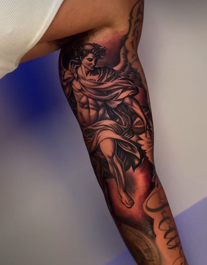 Black and grey archangel sleeve tattoo
