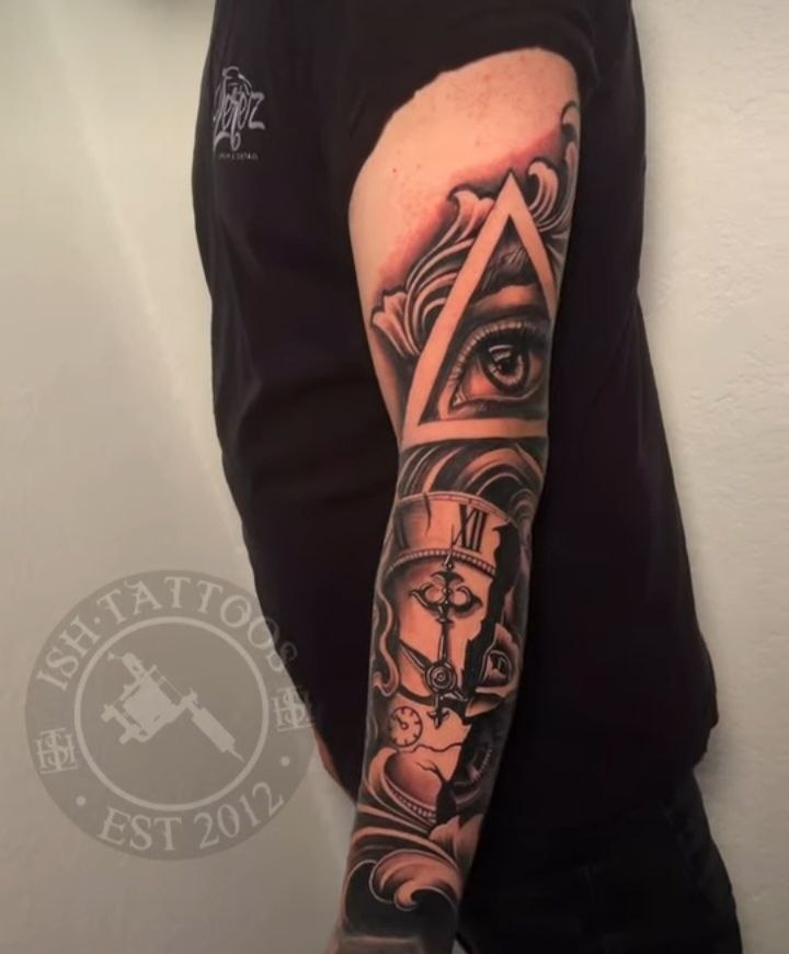 Black and grey all-seeing eye and pocket watch sleeve tattoo