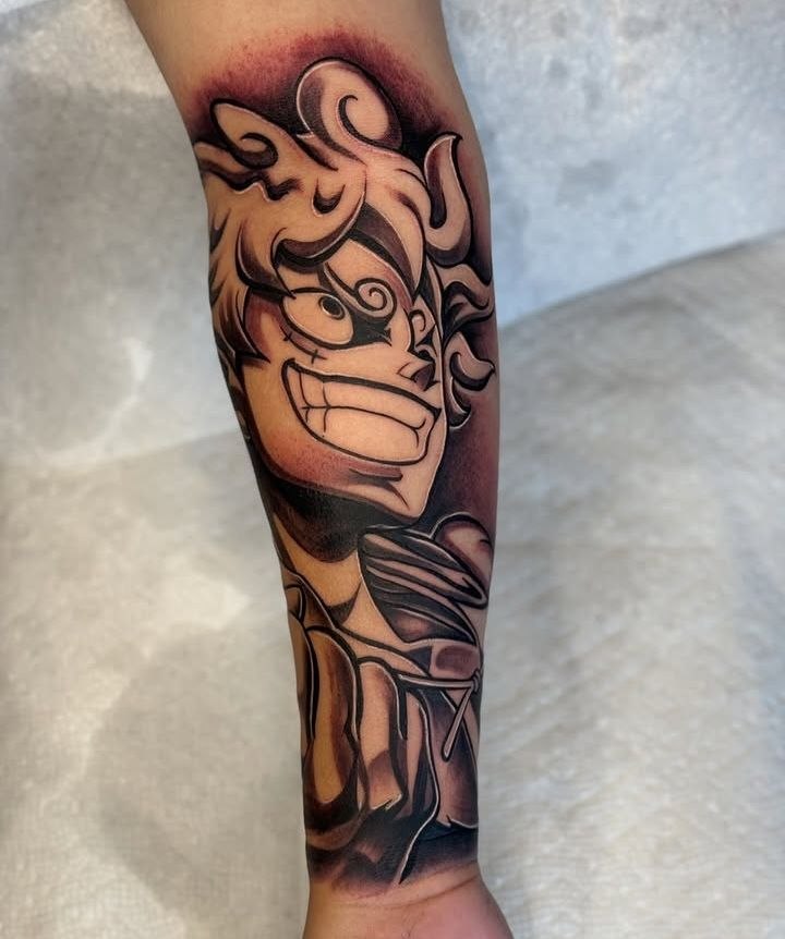 Black and grey anime One Piece Luffy leg tattoo