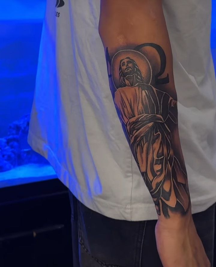 Black and grey Jesus forearm tattoo