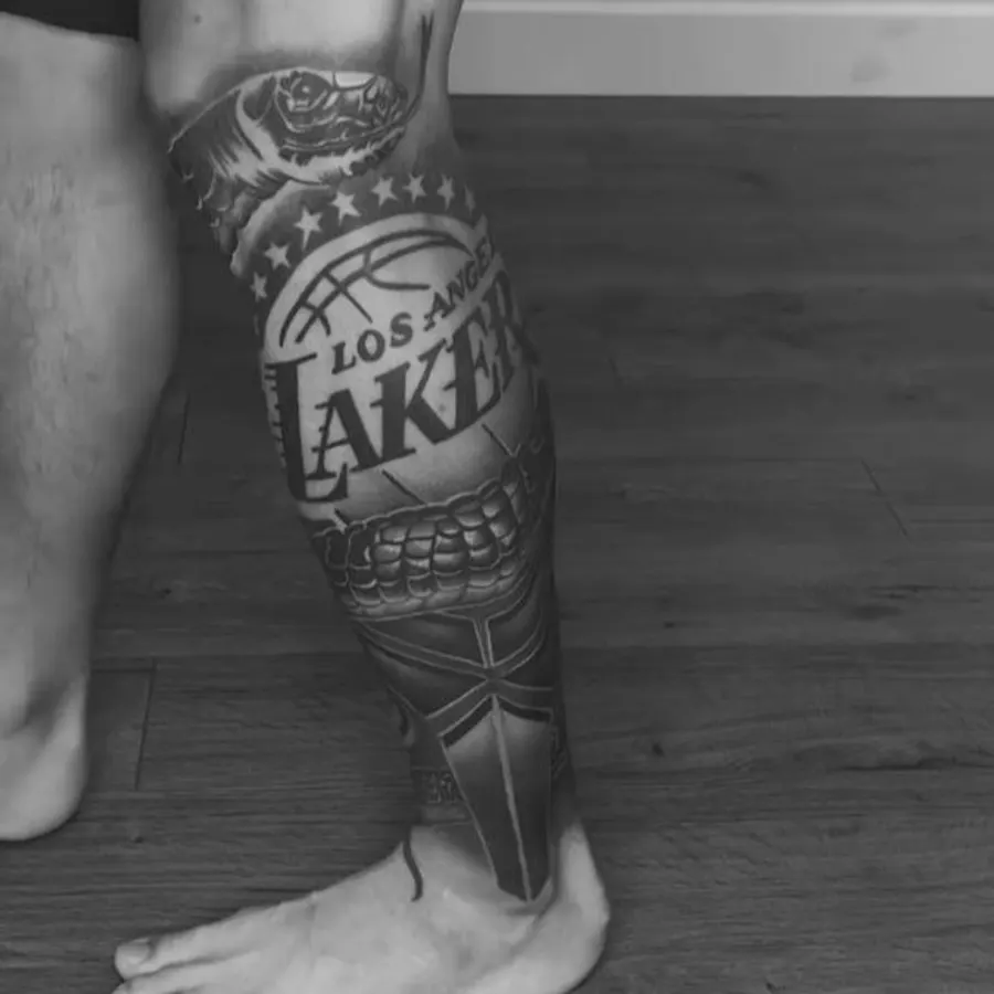 Black and grey Los Angeles Lakers themed leg sleeve tattoo